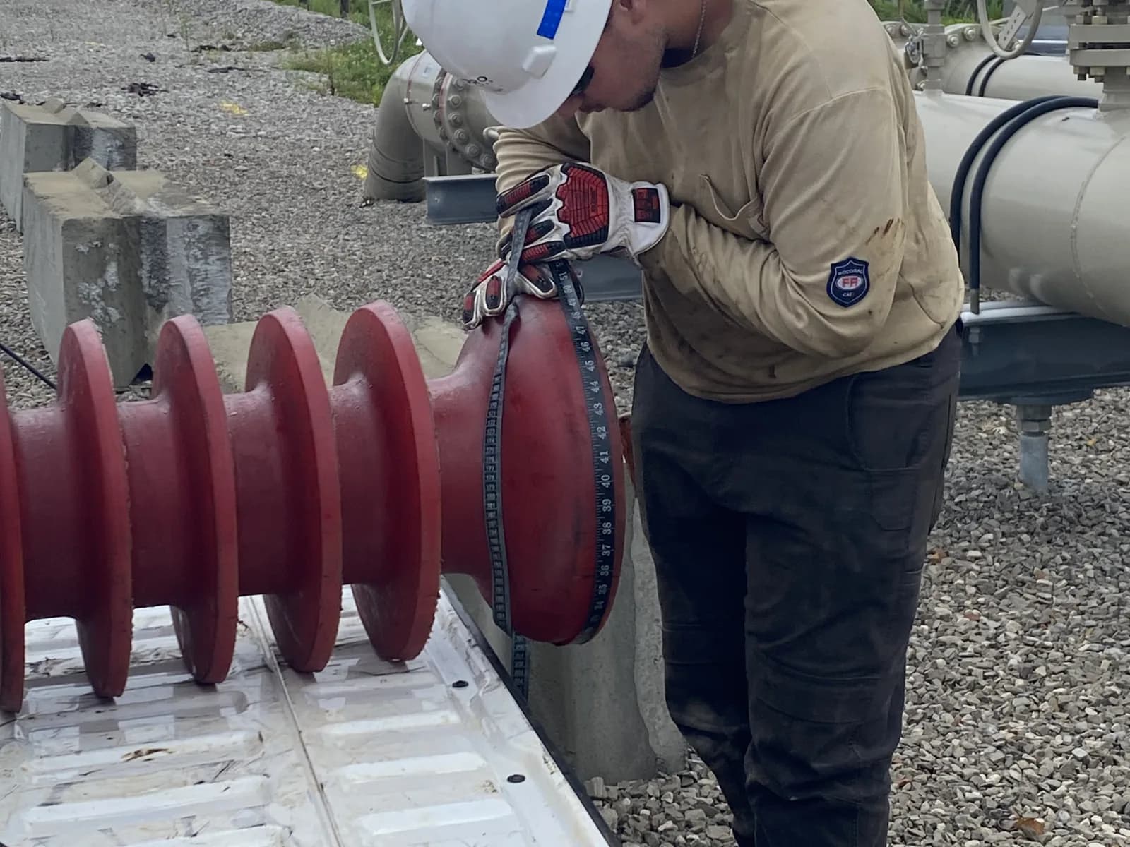 ShalePro pipeline technician measuring a pipeline pig